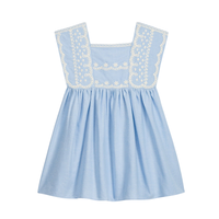 Blue sleeveless dress with white embroidery around arms and along bodice on a white background.