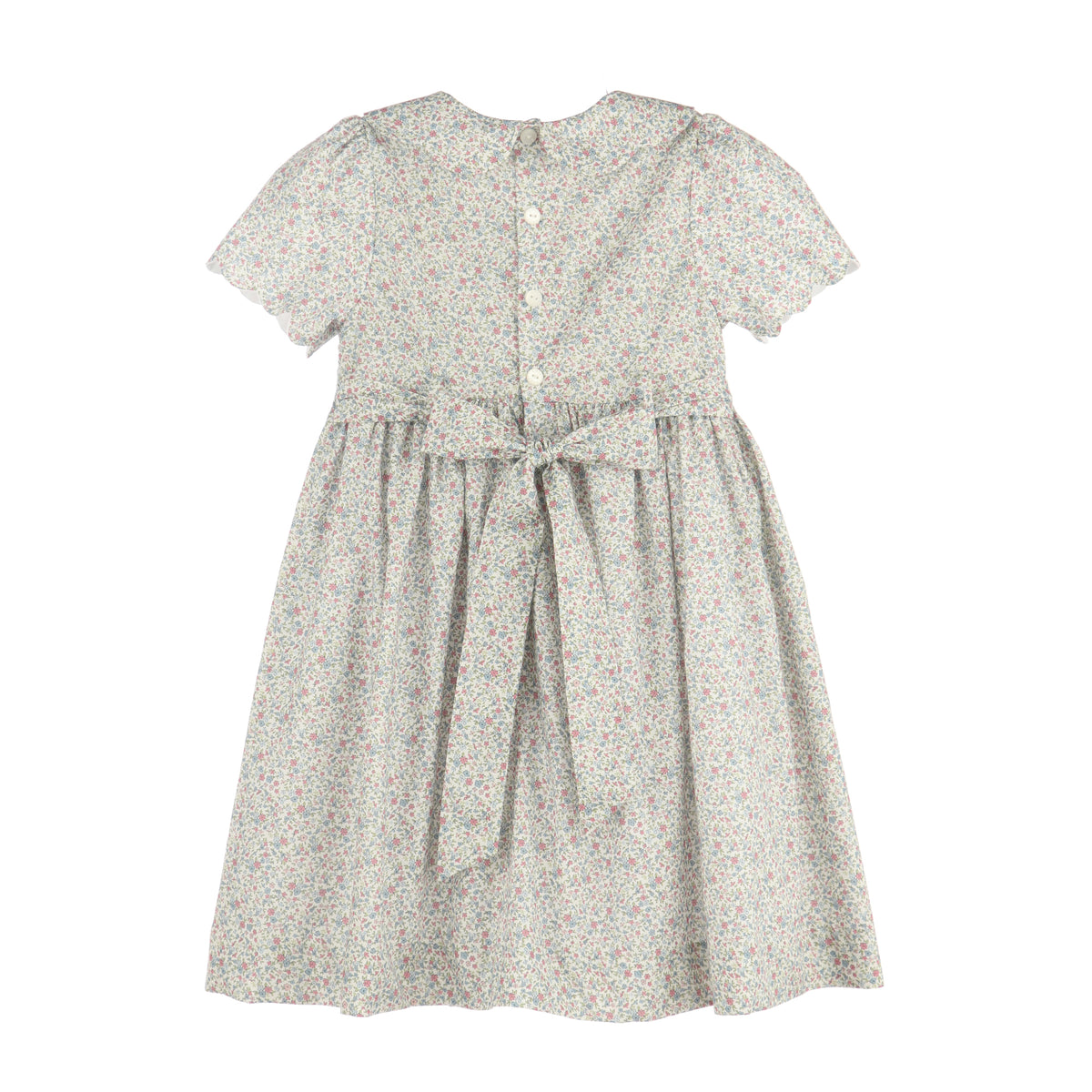 A short-sleeve dress with a small-scale floral print in muted green, pink, and beige tones on a white base. It features a buttoned back, a gathered waist, and a matching fabric tie belt, shown against a plain white background.