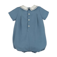 Back view of teal blue boy bubble with white buttons, a white embroidered collar and short sleeves on a white background.