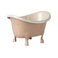 Toy rose colored baby bathtub with white interior on a white background.