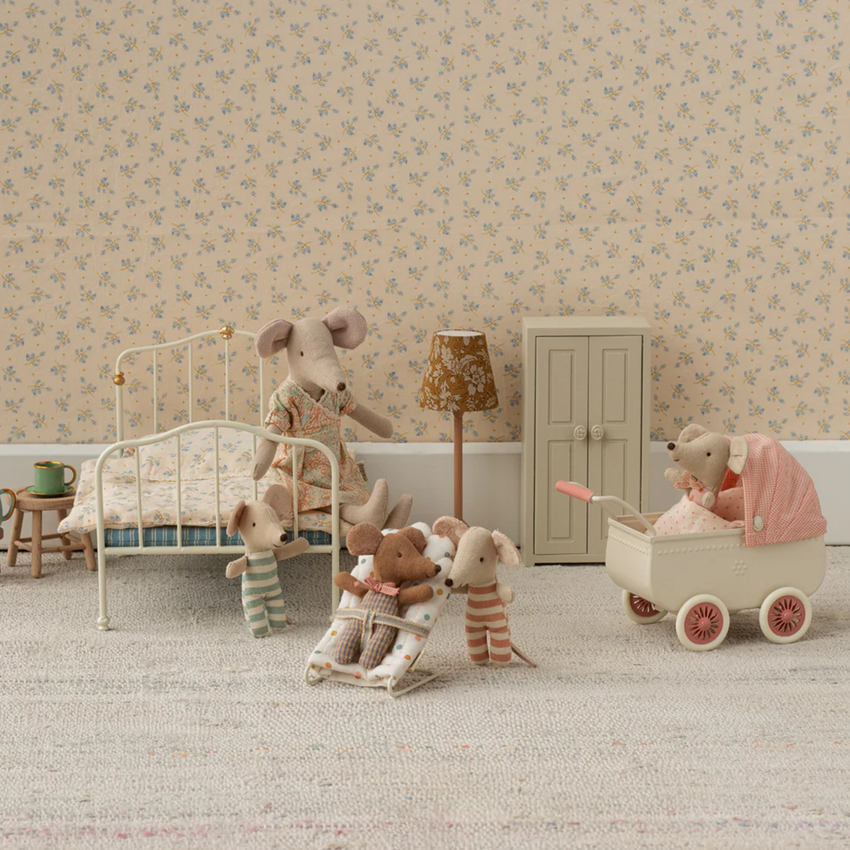 Miniature mice in their bedroom with floral wallpaper and a bed.  Bed, pram and other furniture.