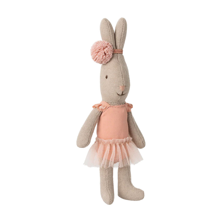 A plush bunny doll in beige fabric wearing a peach-pink tutu and matching pom-pom headband, photographed against a plain white background.