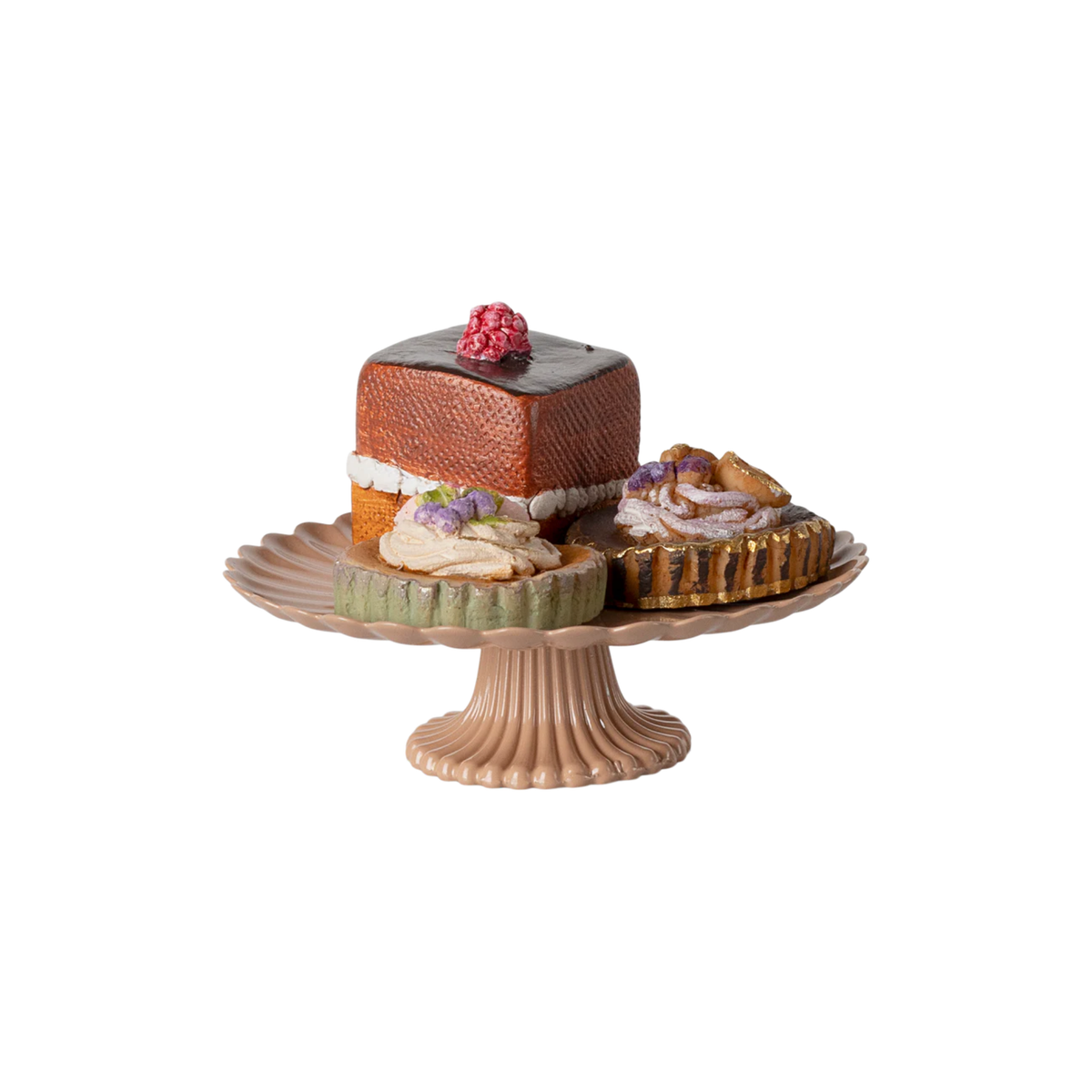 Decorative cake stand with small cakes on a white background.