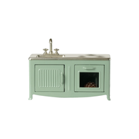 Mint colored kitchen stove and sink on a white background.