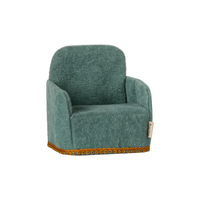 Toy mouse size green armchair with decorative trim on a white background.