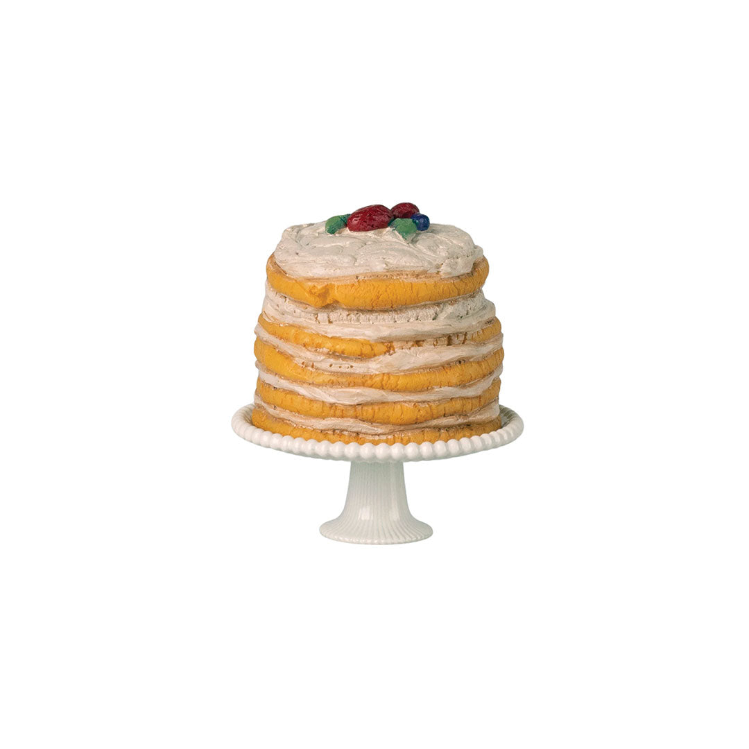 Toy multi-layer cake on a white background.