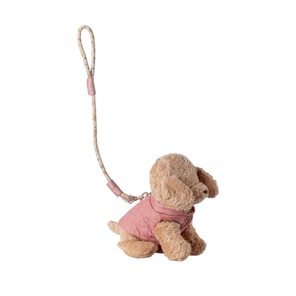 Plush dog toy with a pink jacket and leash on a white background.