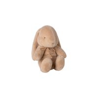 Plush bunny toy with a bow on a white background