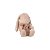 Plush bunny toy with a bow on a white background.