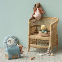 Wicker chair with toys in a child's room.  Bunnies, puppy, and pig lounging on chair and in a carrier.