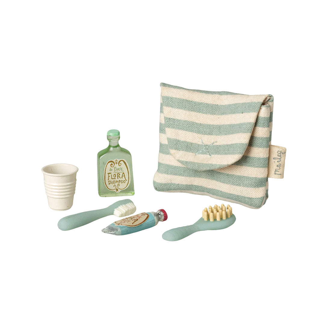 Toy set of children's bathroom accessories including a cup, bottle, toothbrush, and towel on a white background.
