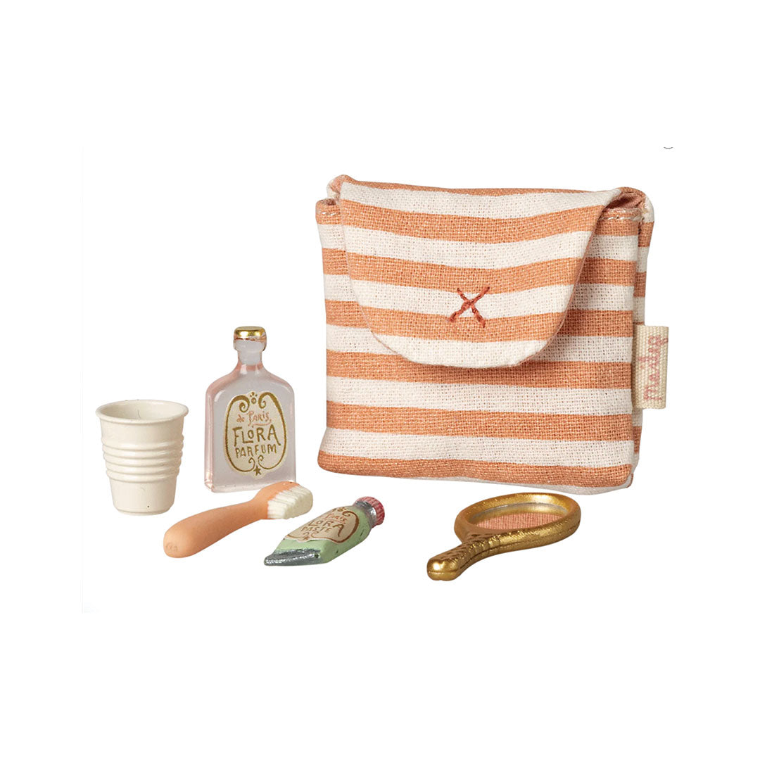 Toy striped bag with miniature accessories on a white background.