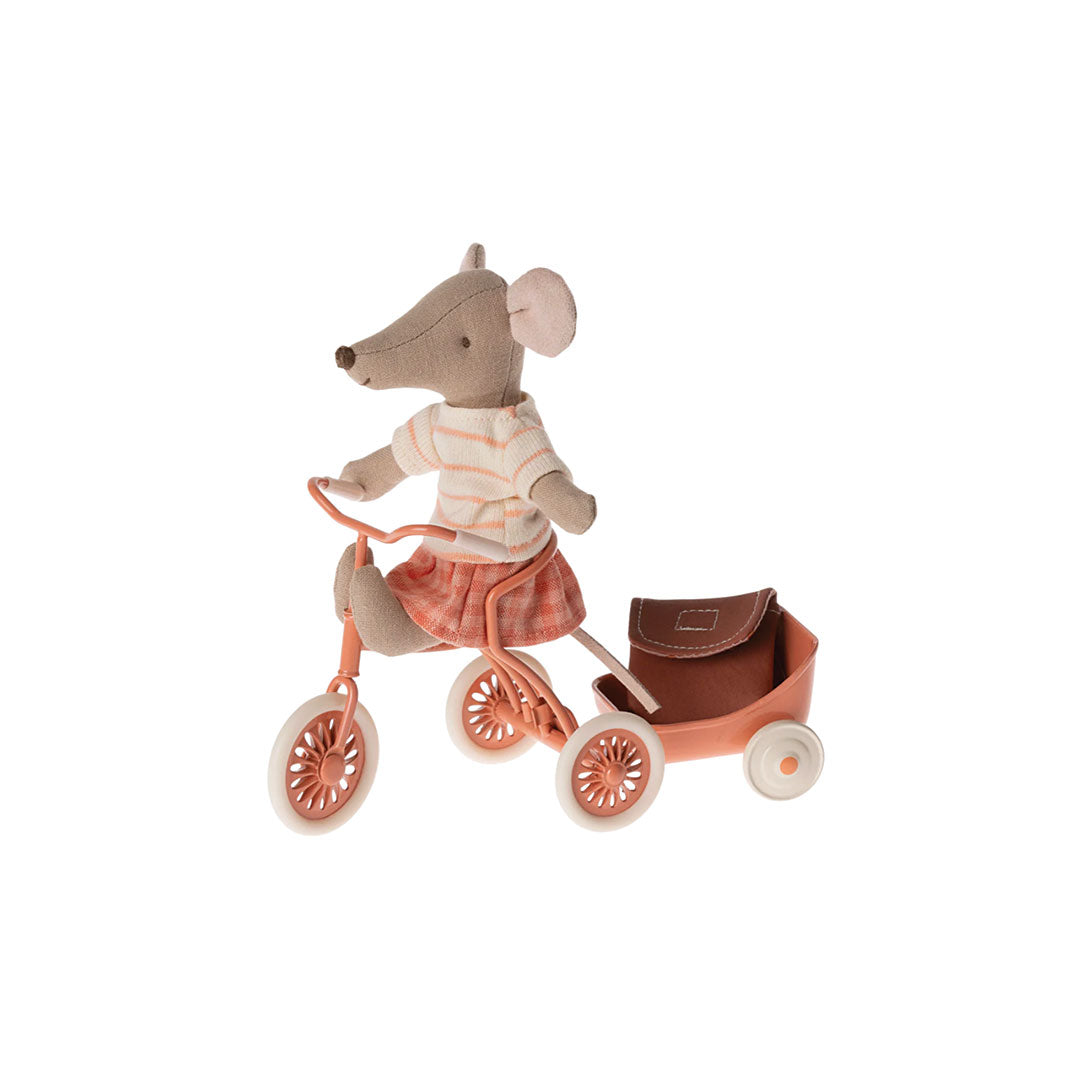 Small mouse figure riding a tricycle with a cart on a white background.