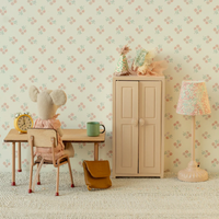 Toy mouse room with desk, chair, cabinet, and toys against floral wallpaper.