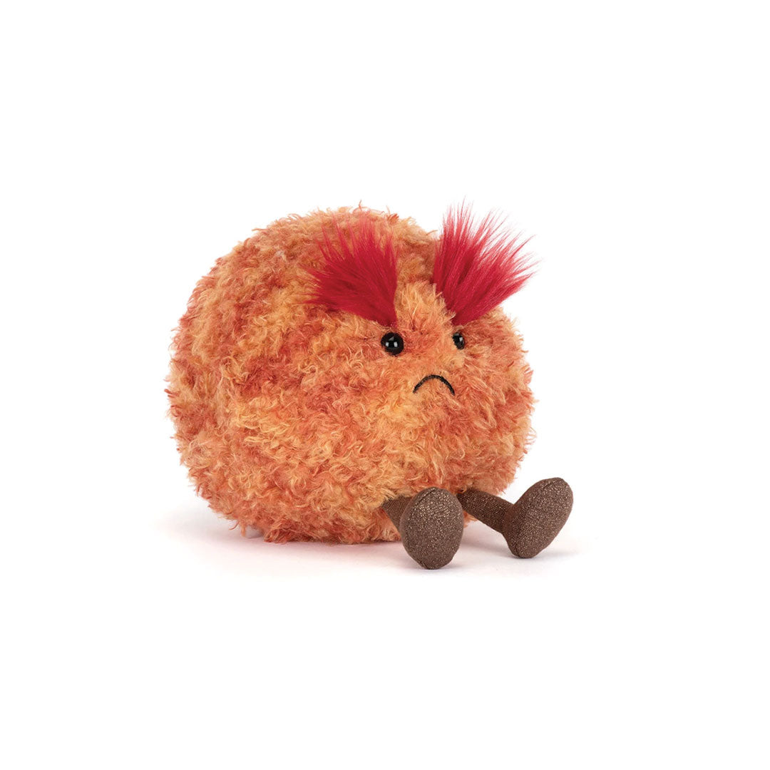 Plush toy resembling the planet Mars with   red hair on a white background.