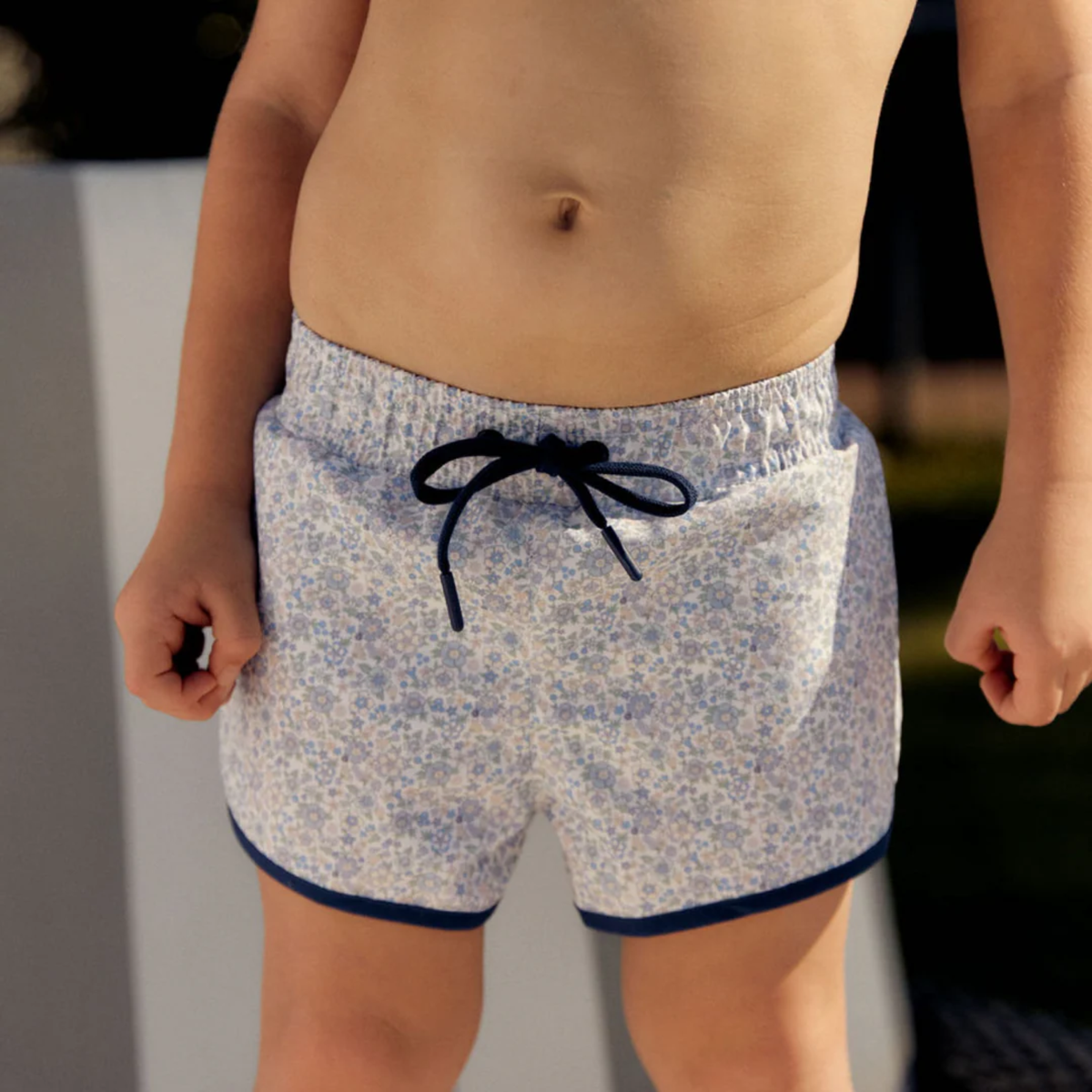 Floral-patterned boardie shorts with dark blue trim and drawstring 