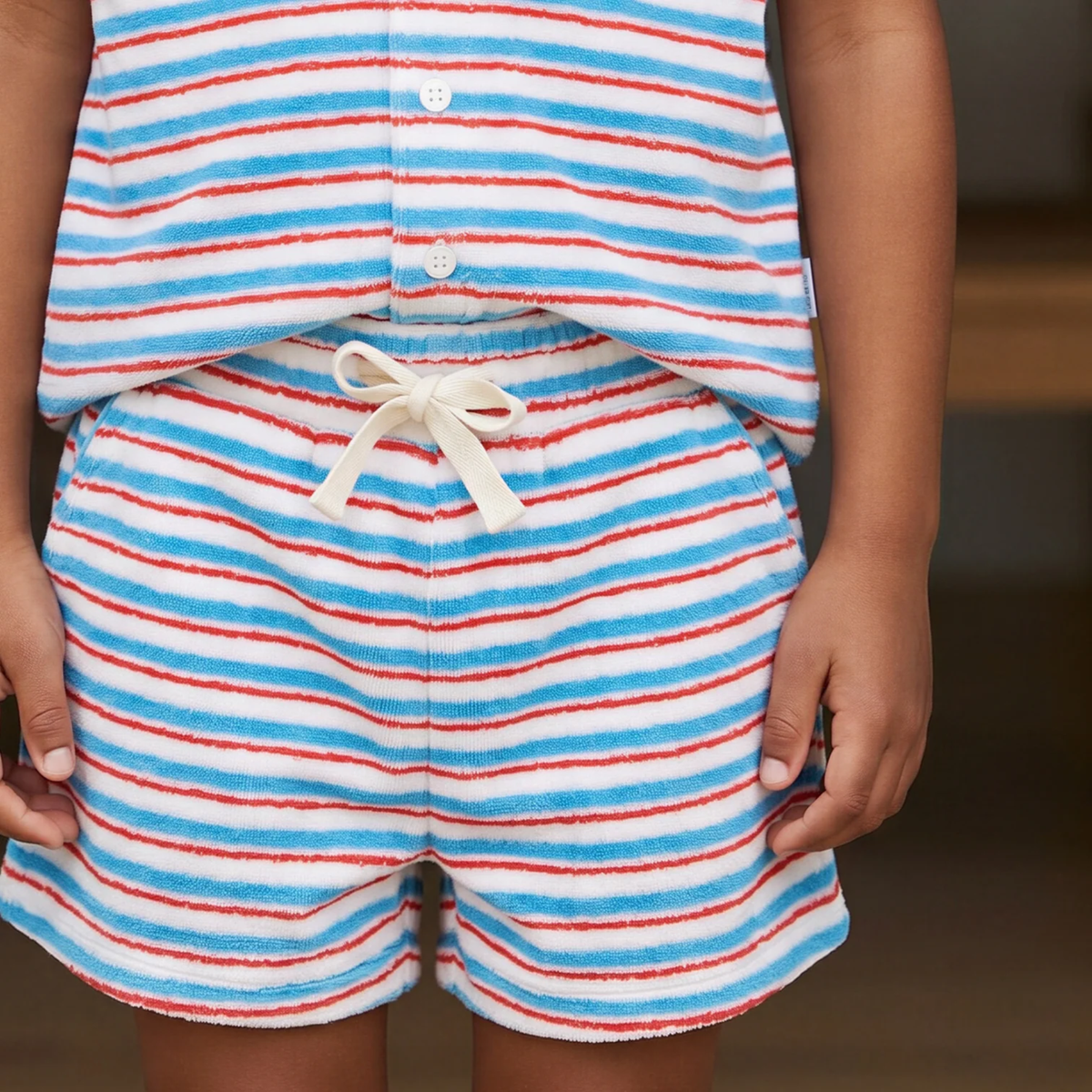 Person wearing a red, white, and blue striped outfit with shorts and a top.