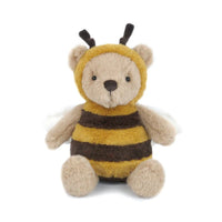 A plush teddy bear dressed as a bee, featuring a yellow and dark brown striped fuzzy body, a beige face and paws, and small black antennae, photographed on a plain white background.