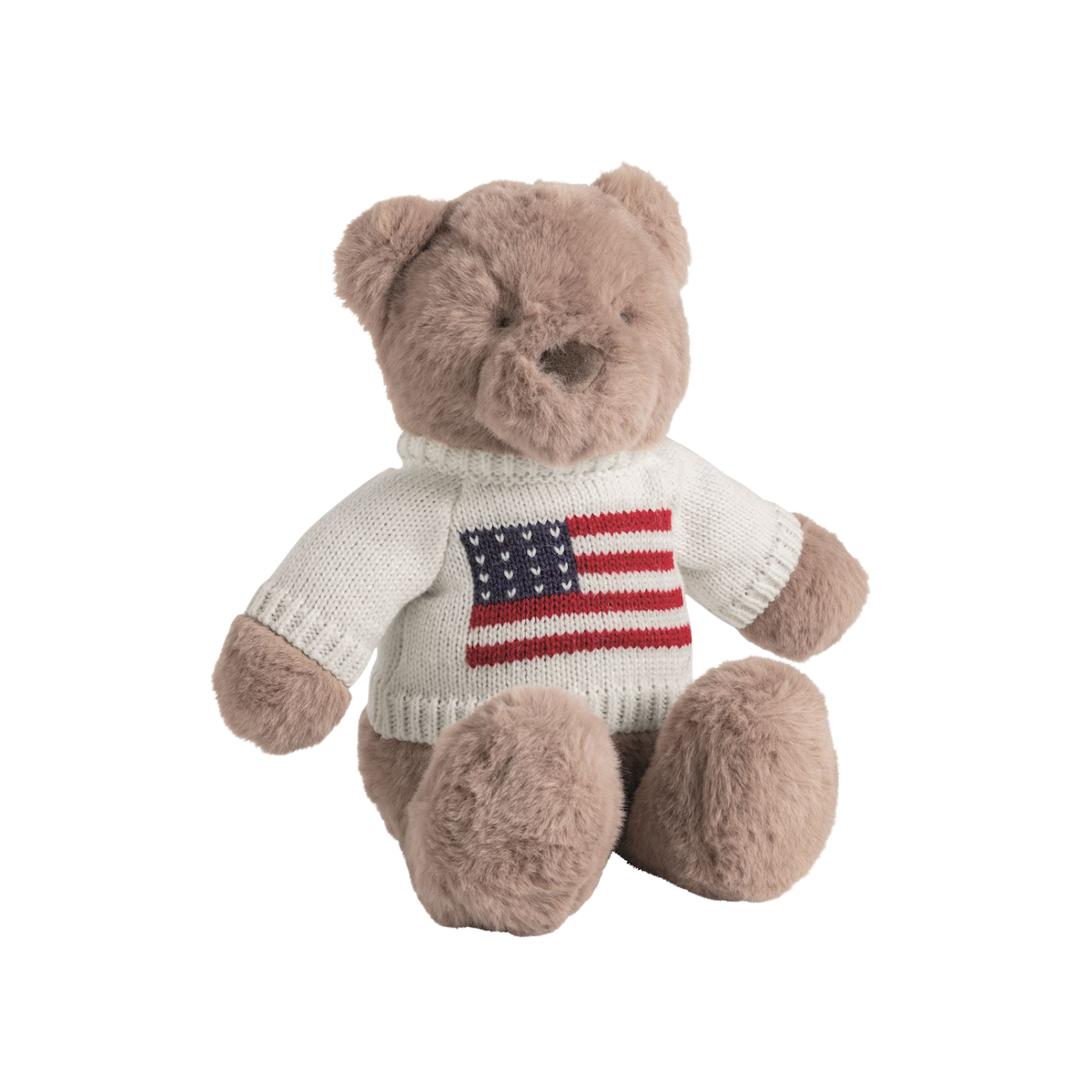 Plush teddy bear wearing a sweater with an American flag design on a white background.
