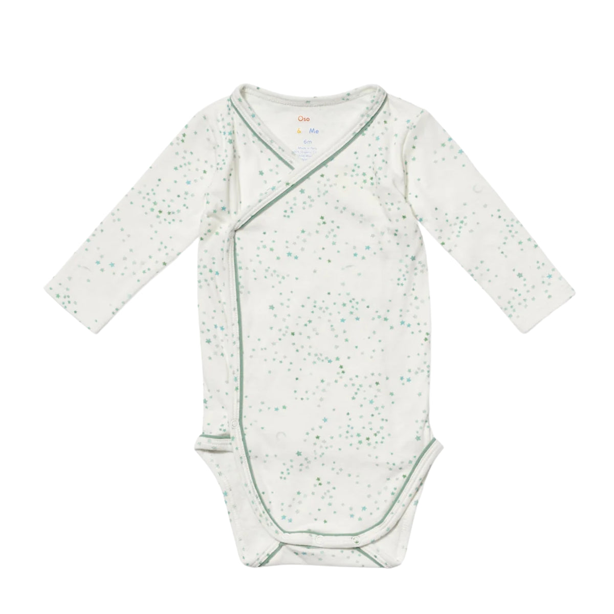 A long-sleeve baby crossbody wrap bodysuit in white with a light green speckled pattern and green piping, laid flat on a white background.