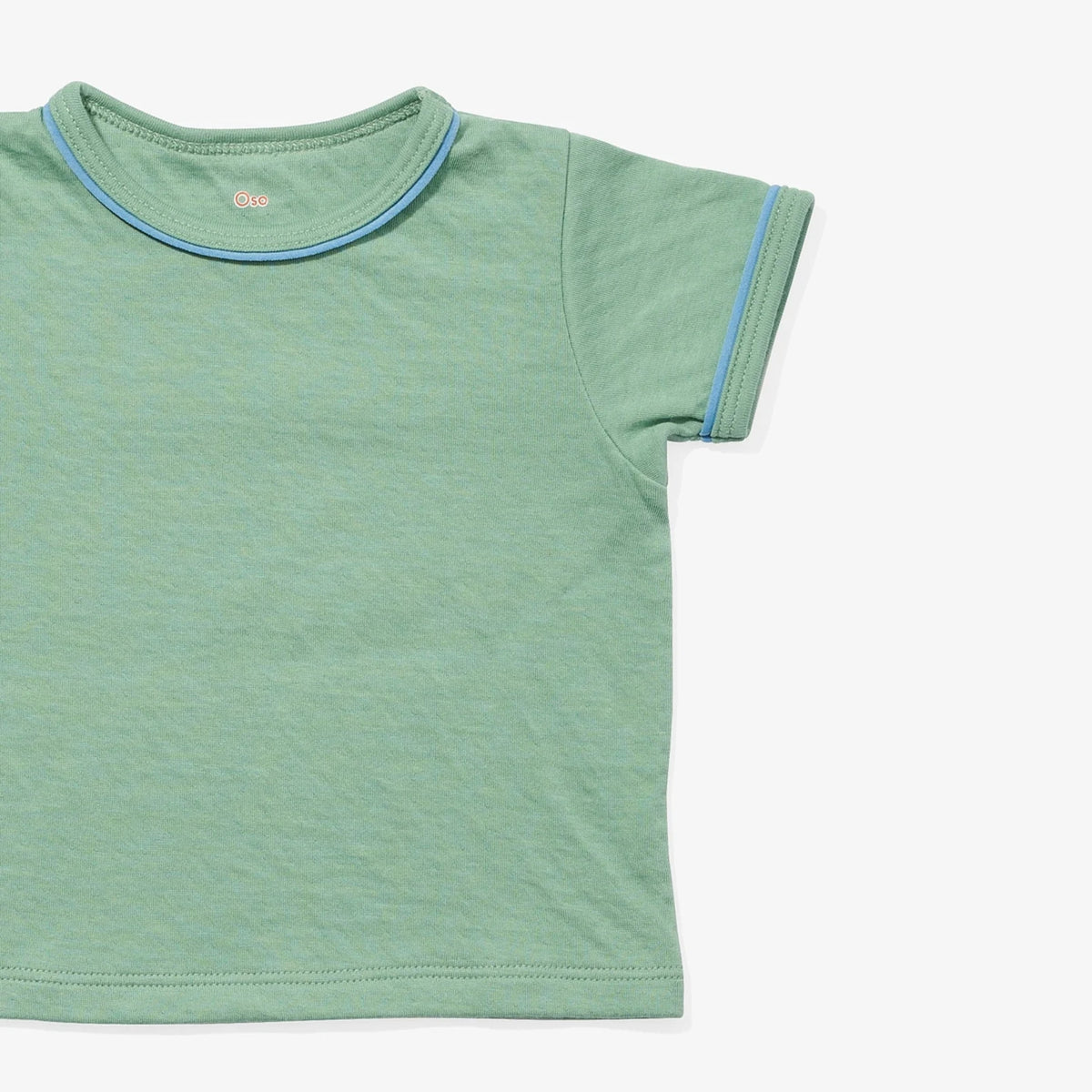 A close-up of a light green short-sleeve ringer t-shirt with light blue contrast stitching on the collar and sleeve cuffs, shown on a plain white background.