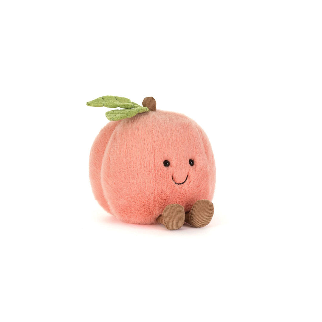 Plush peach toy with a smiling face on a white background.