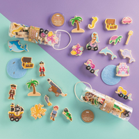 Collection of pirate and mermaid - themed decorative wooden toys on a purple and teal background.