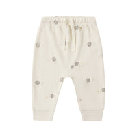 White baby pants with hedgehog patterns on a white background.