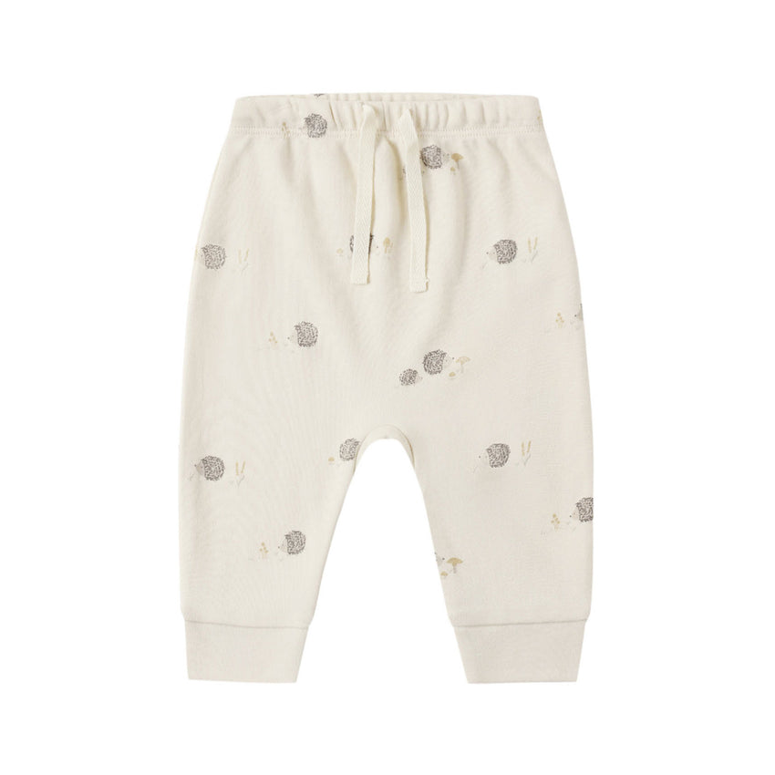White baby pants with hedgehog patterns on a white background.