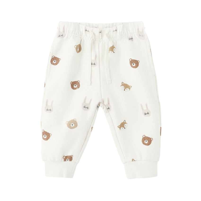 White baby sweat pants with brown bear patterns on a white background.