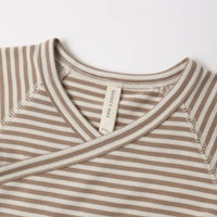 Close-up of a striped baby wrap top with a V-neck and crossover front on a white background.