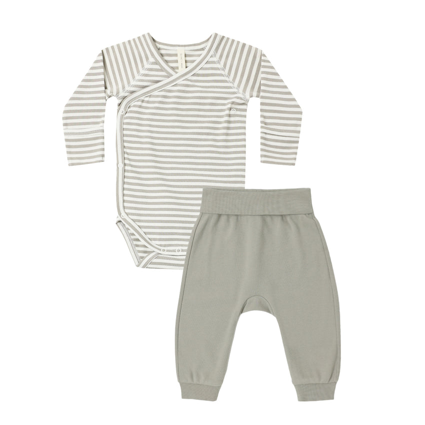 Baby outfit with striped onesie and  pants on a white background.