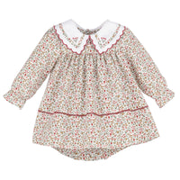 A long-sleeve dress with a dense red, green, and yellow floral print on a cream background, featuring a white Peter Pan collar with red scalloped trim.