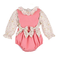 Pink baby romper with floral long-sleeve top and bows on the front on a white background.