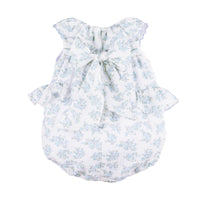 Back view of a white baby romper with blue floral pattern and ruffles on the side on a white background.