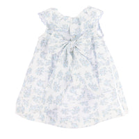 Back view of a white dress with blue floral pattern and bow on a white background.