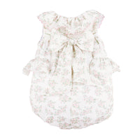 Back view of a pink floral baby romper with side ruffles on a white background.