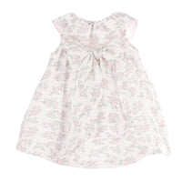 Back view of a pink floral dress with a bow on a white background.