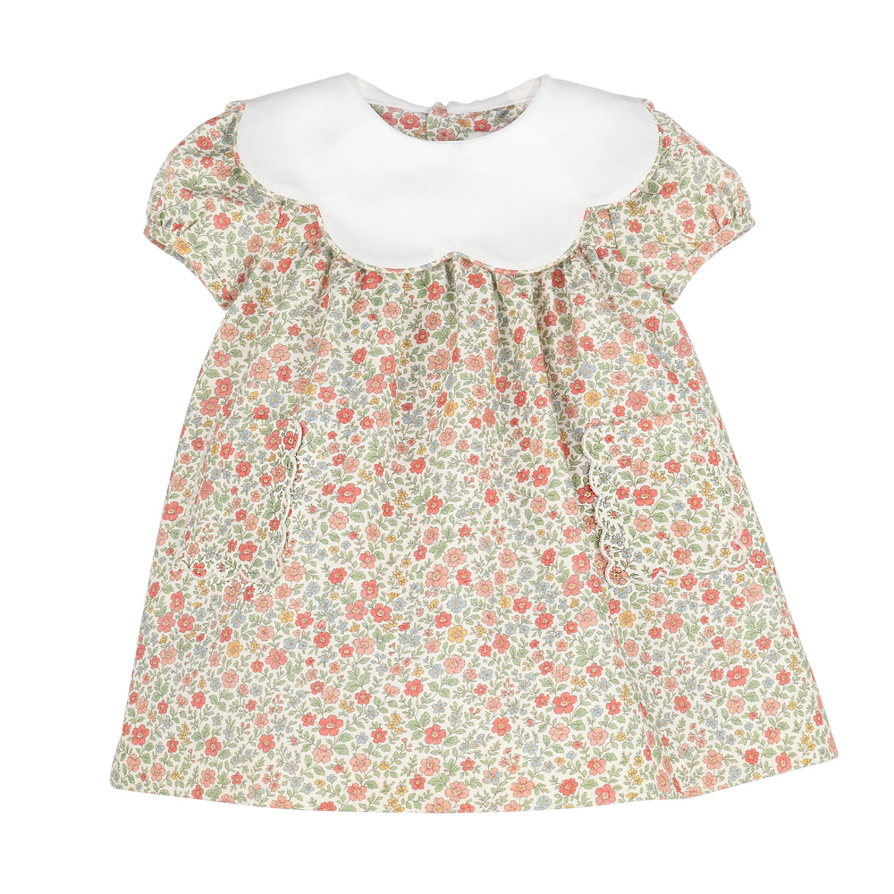 A girl's short-sleeve dress featuring a white scalloped Peter Pan collar and a dense small floral print on a light beige background with pink, red, and green flowers.