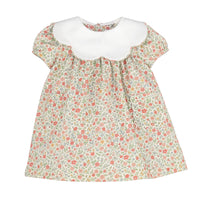 A girl's short-sleeve dress featuring a white scalloped Peter Pan collar and a dense small floral print on a light beige background with pink, red, and green flowers.