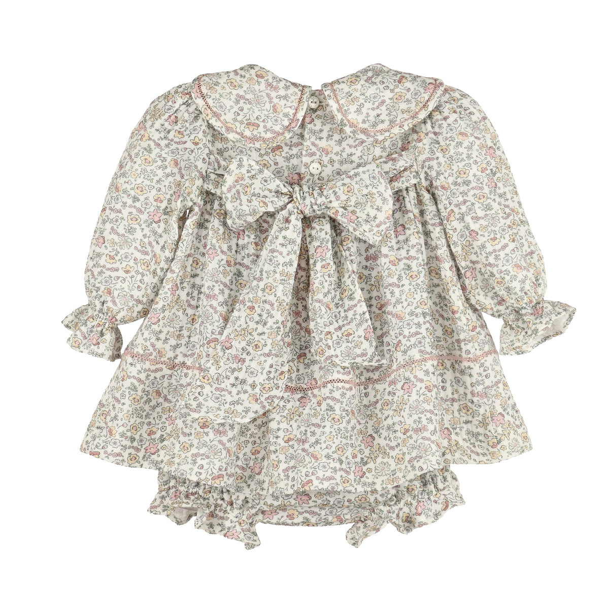 Back of floral dress with long sleeves and a big bow on a white background.