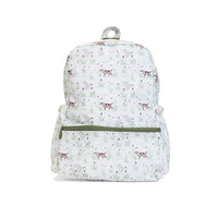A white backpack with an all-over print of small brown dogs and green leaves, featuring a green zipper on the front pocket and a gray top handle.