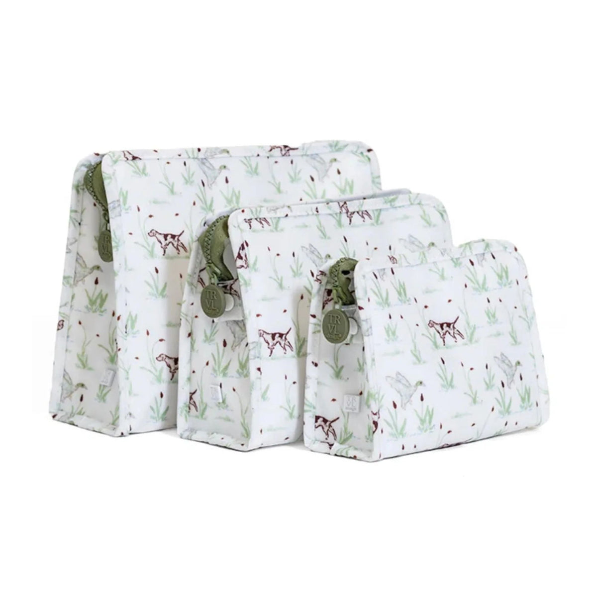 Three matching fabric pouches in a nested set, featuring a white background with  brown dogs and grass pattern, olive green zipper pulls, and round decorative tags.