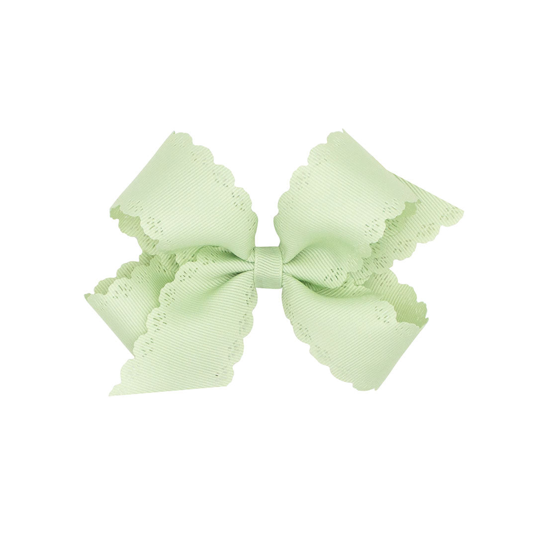 Seafoam bow with scalloped edges on a white background.